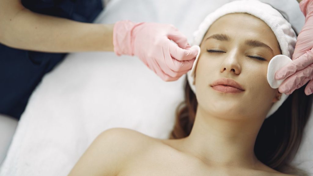 Woman receiving a facial light treatment