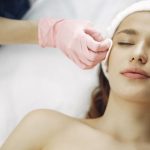 Woman receiving a facial light treatment